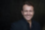 A headshot of Tim Smiling