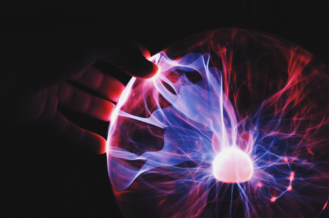 Hand touching an electric sphere