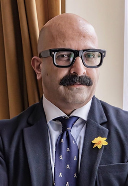 Portrait of Dr. Az Hakeem, Consultant Psychiatrist and Medical Psychotherapist, seated in a professional setting with a calm,