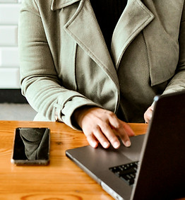 Person working on a laptop during a virtual meeting.