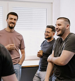 Adults talking together in a group setting.