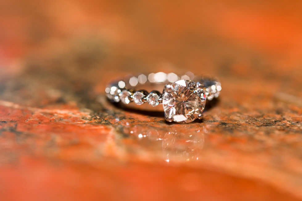 a close up of a diamond ring on a table