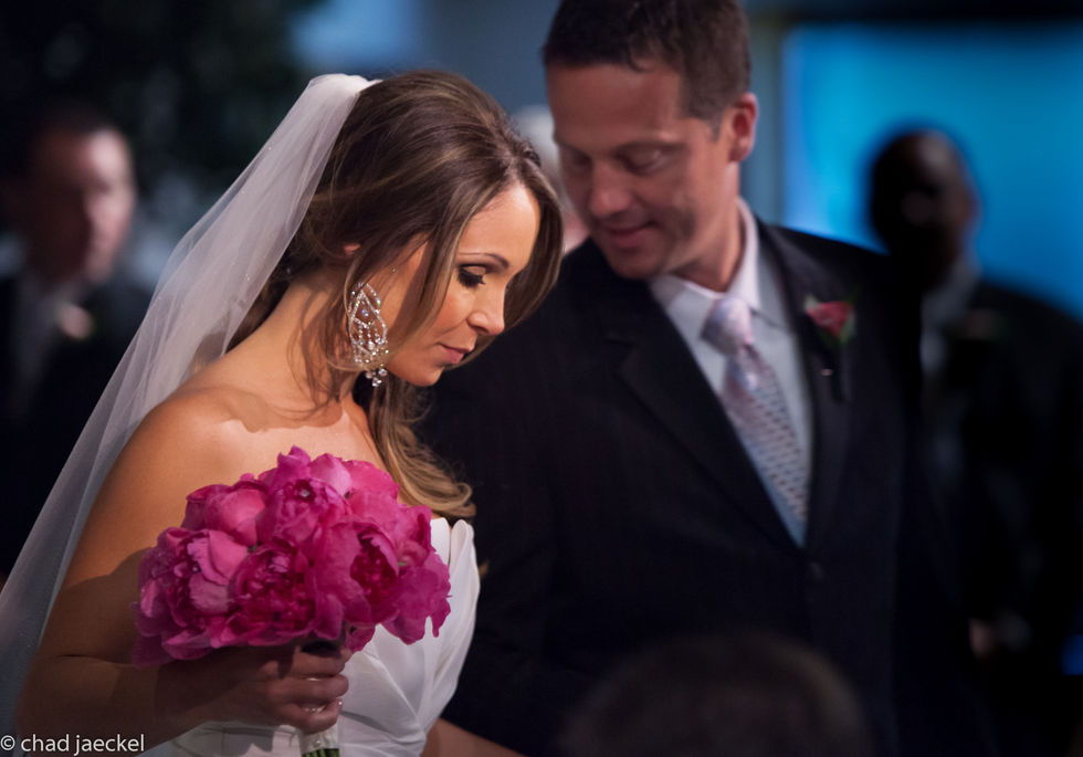the bride is holding a bouquet of pink flowers