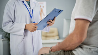 Male patient speaking with a healthcare provider during a vasectomy consultation about the procedure and recovery