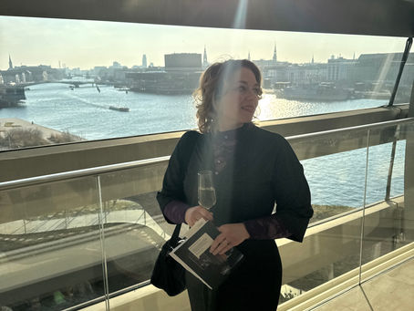Frederikke at the copenhagen opera house holding a glass of champagne