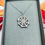Thumbnail: silver cobweb pendant on chain presented in grey gift box
