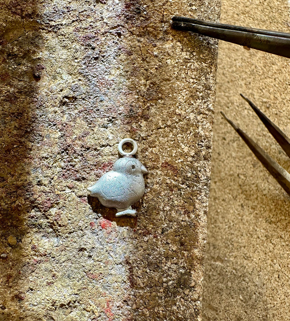Thumbnail: sterling silver Easter chick being hand made on work bench