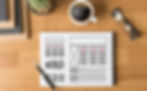 a notepad with coffee, glasses, cactus and books on a wood desk
