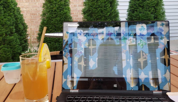 Birch Road member working from the patio space at the Roscoe Village clubhouse in Chicago.