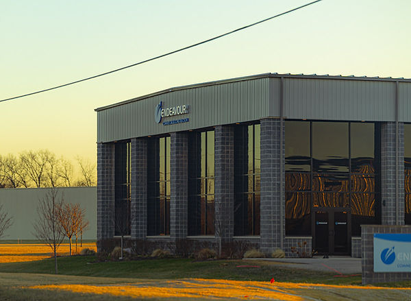 Wide exterior view of the Endeavor Commercial building at sunset.
