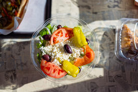 Top down view of a salad on the table of a restaurant booth