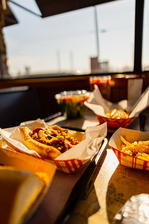 Sun light is shining on a table with several different kinds of food at the King Gyros in Dunlap