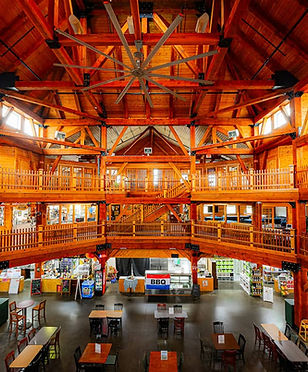 Interior of Southgate Crossing in Elkhart, Indiana, showing the large Amish built peg and beam market hall with wood balconies, vendor booths, and seating below.