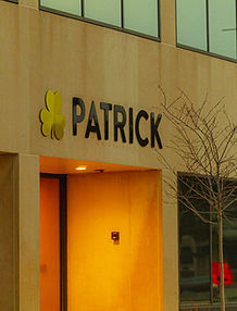 Patrick Industries corporate office building at 107 W Franklin Street in downtown Elkhart, Indiana with company sign on modern stone facade.