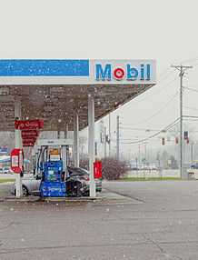 Wide view of the mobile gas station at the intersection of County Road 17 and State Road 120 with snow falling, in Elkhart.