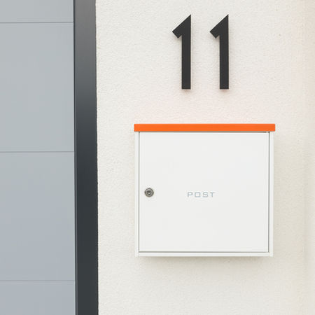 External post box finished in LRAR orange at Eileen Avenue, Brighton, by LRAR Architects, Brighton