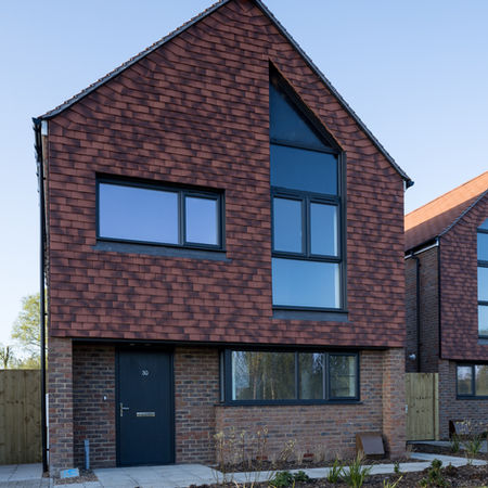 Close‑up of material detail: traditional brickwork, timber joinery, vernacular roofing elements