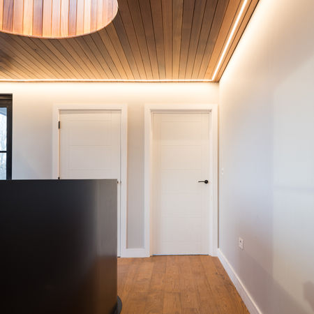 view of the light-filled 1st floor landing and staircase banister
