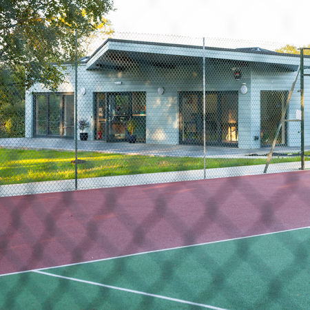 View of Plumpton Tennis Club clubhouse overlooking the tennis cour