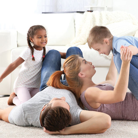 Happy family on the flow of a living room.