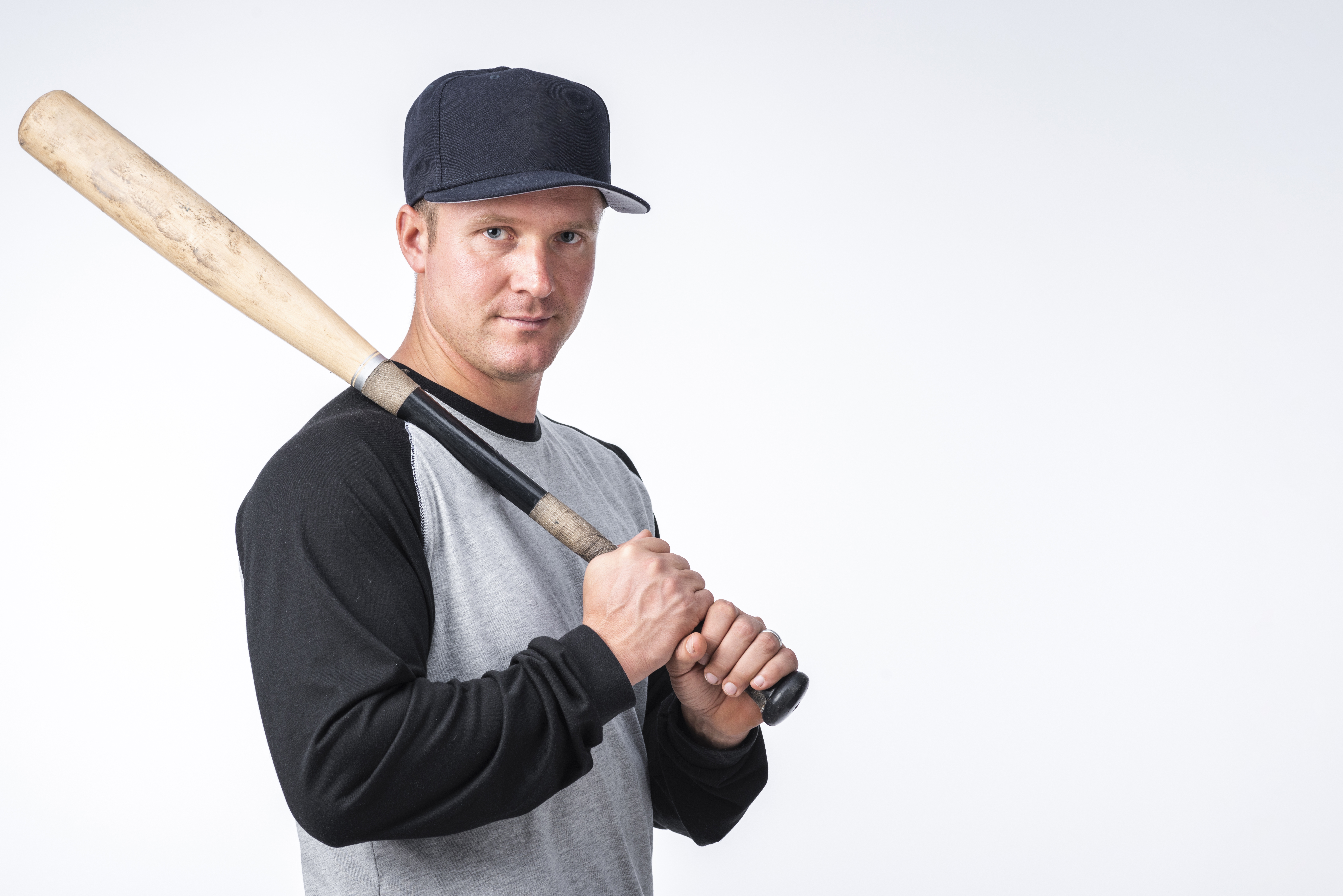 man-with-cap-posing-with-baseball-bat.jpg