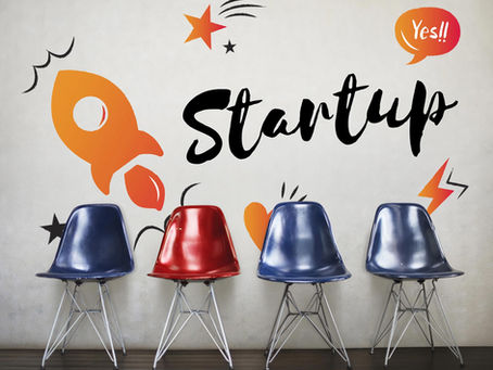 four chairs in front of a wall with "Startup" painted on it