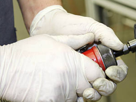 a machinist deburring a product