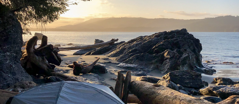 A tent at sunrise on a beach