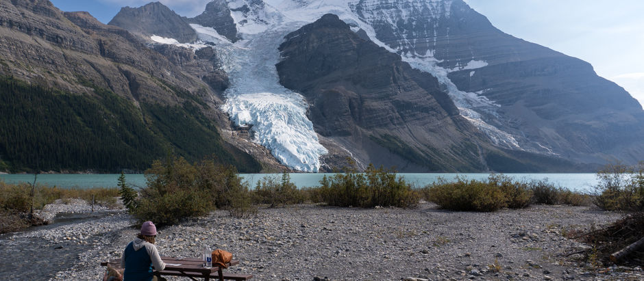 A woman sitting at Berg Lake in Mount Robson Provincial Park