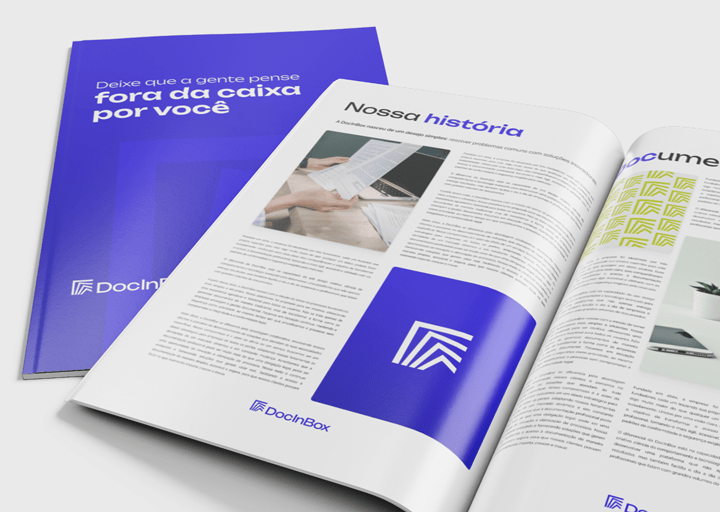 Imagem mostrando uma revista da DocInBox. A capa da revista é azul com a frase 'Deixe que a gente pense fora da caixa por você' e o logotipo da DocInBox. Ao lado, a revista está aberta, exibindo páginas internas com texto, imagens e o mesmo logotipo destacado em azul.