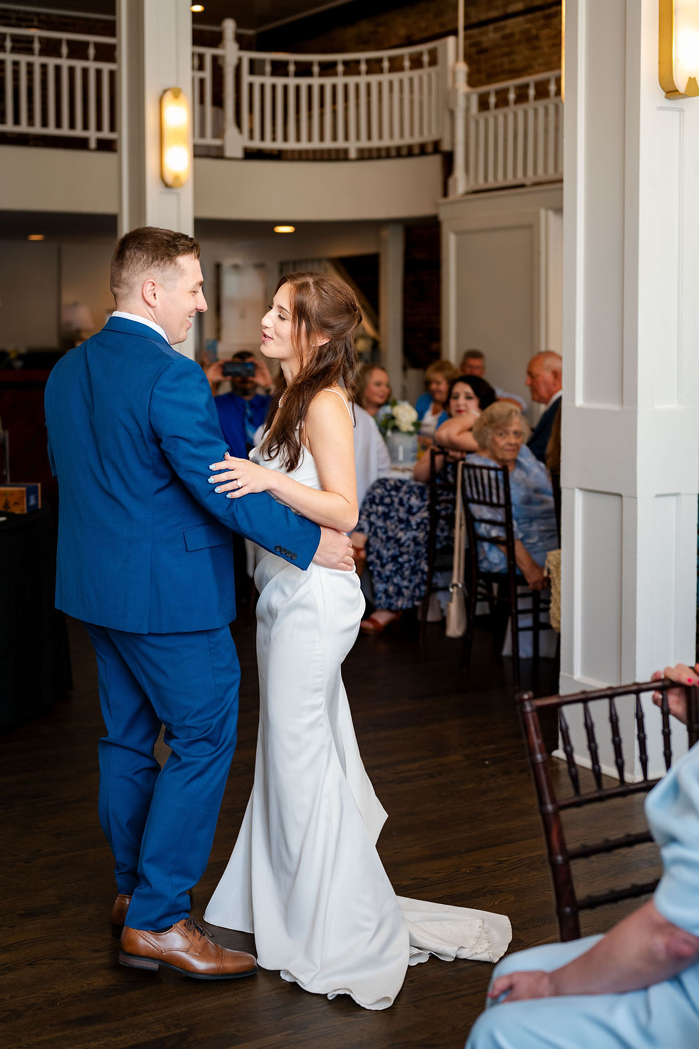 Bride and groom dancing together inside 128 South reception hall for first dance in Wilmington NC