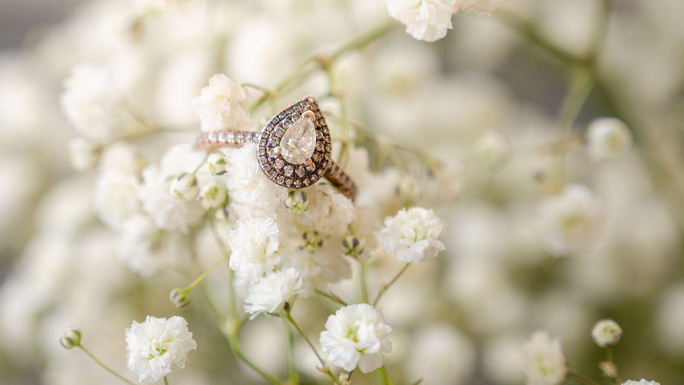 Close-up of a bride's diamond engagement ring resting on a bouquet of flowers at Pine Log Venue in Whiteville, NC.