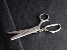 Mundial pinking shears on black sewing fabric