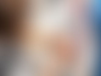 Seamstress pinning white fabric on an adjustable dress form.