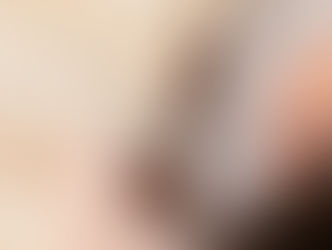 Closeup of beige corset with vertical boning and white lacing on a dress form.