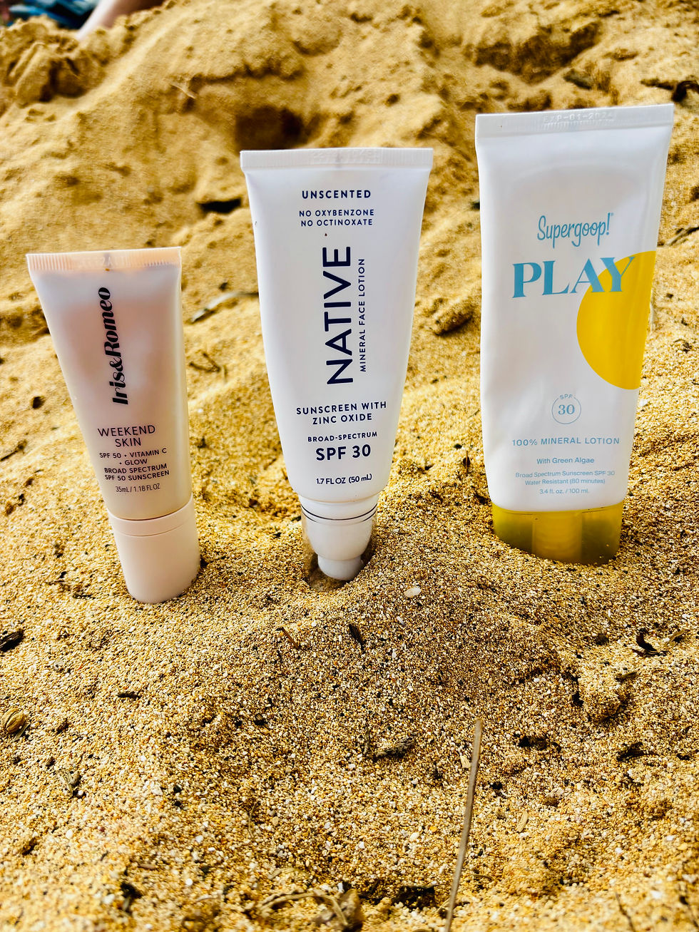 Three sunscreen bottles on the beach