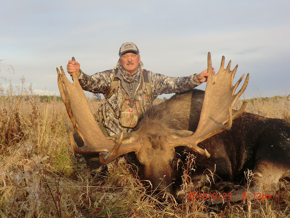 Hunter holding moose antlers at Alaska Expedition Lodge.
