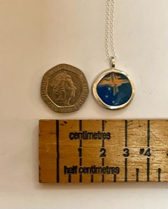 Thumbnail: Night Sky silver necklace next to a 20p for scale