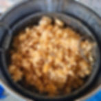 Bees wax inside a metal container ready for processing
