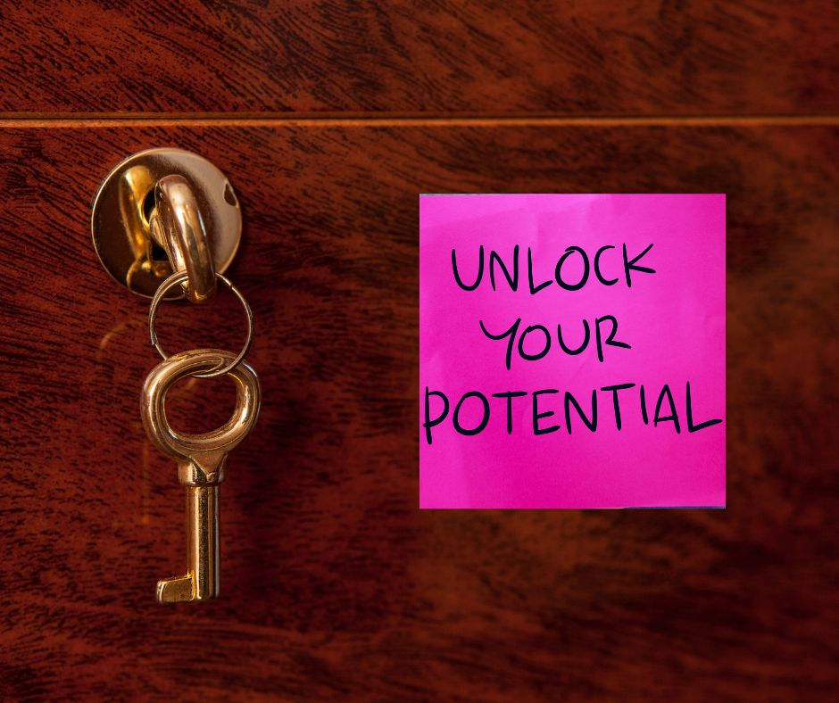 Unlocking professional Potential a brass key and lock in a dark wooden door and a pink post-it note
