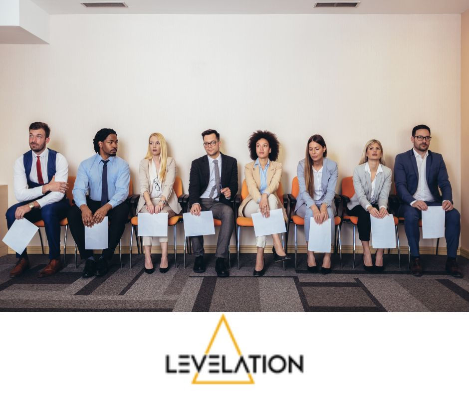 Be Authentically You for interviews - A row of candidates , male and female sit in a corridor waiting to be called to an interview