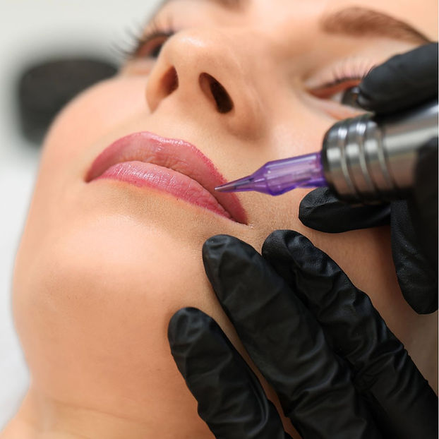 Permanent Makeup Artist applying permanent lip colour treatment