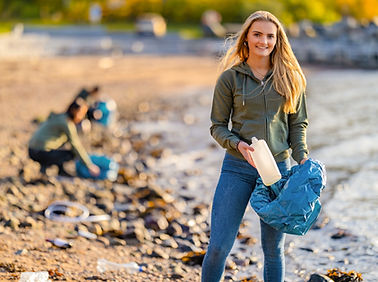 Photo of a college student at a beach cleanup.