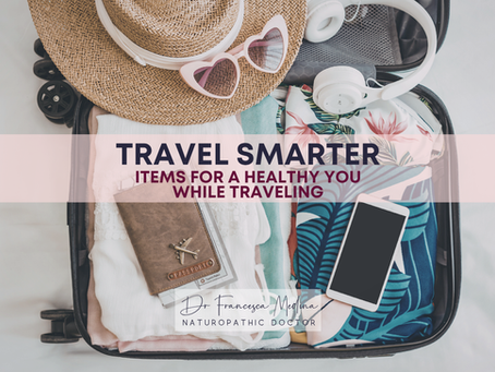Open suitcase packed with beach clothes, hat, sunglasses, passport, phone and headphones; text says Travel Smarter