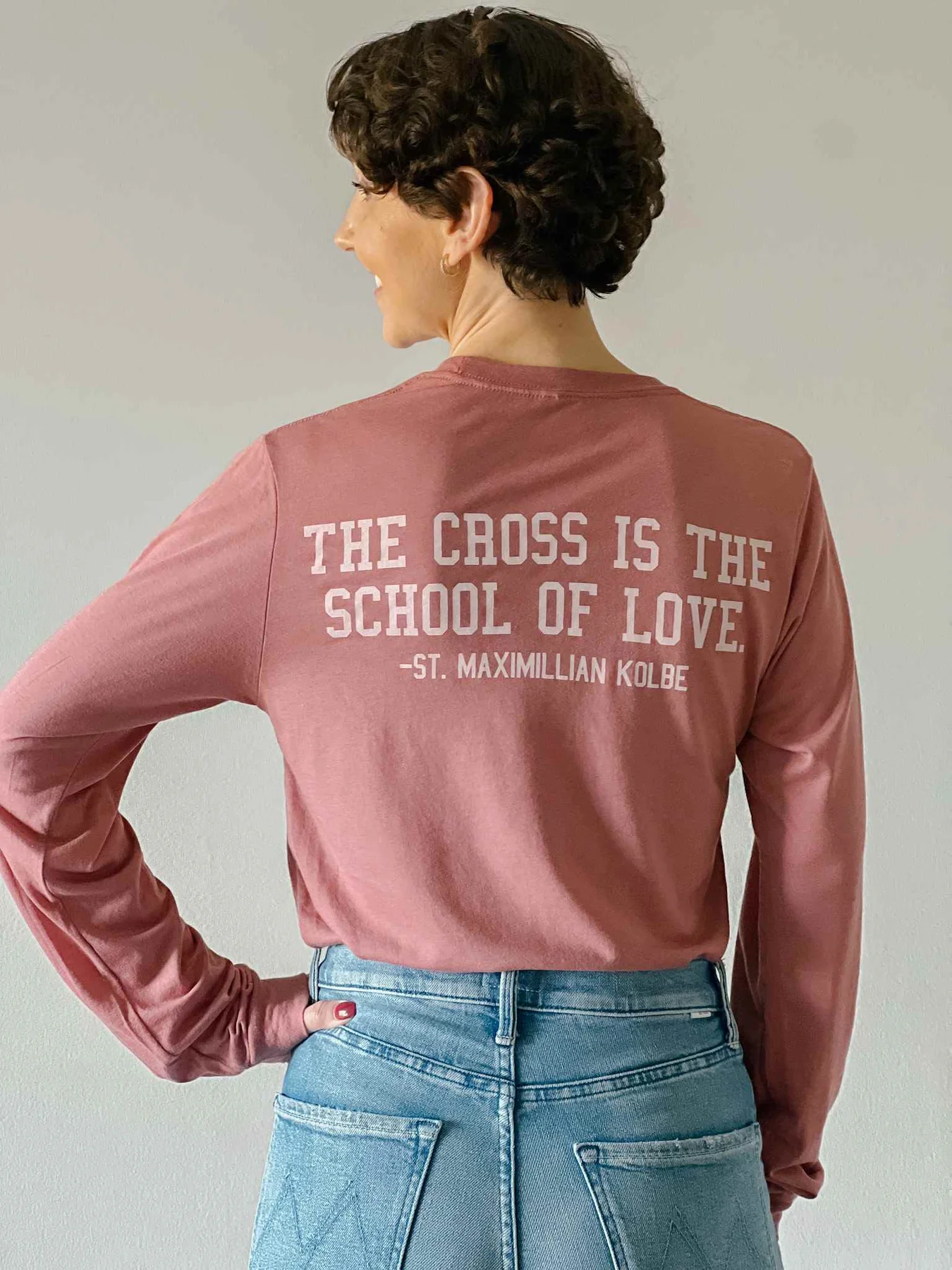 "The Cross is the School of Love" muted pink longsleeve tee. Perfect for those summer nights you need a little something extra around the campfire. 