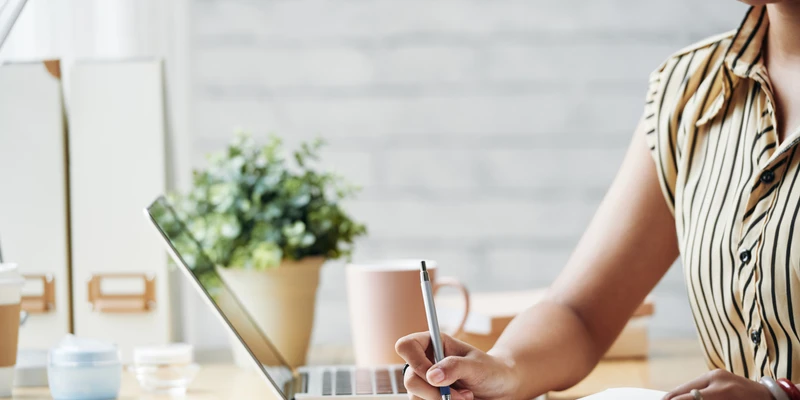Woman writing in a journal during a guided writing program for self-discovery, clarity, and personal growth