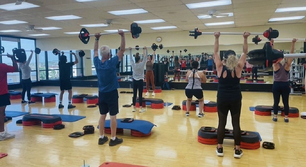 Group fitness class with members of different experience levels training together