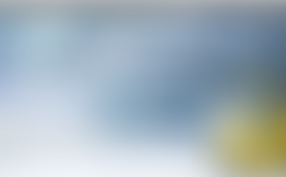 A forklift parked inside a large, modern warehouse with a high ceiling and bright lights.