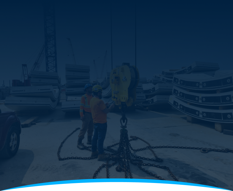 Background graphic of job site with stacked concrete segments, cranes, and a yellow lifting device equipped with a HoistCam.