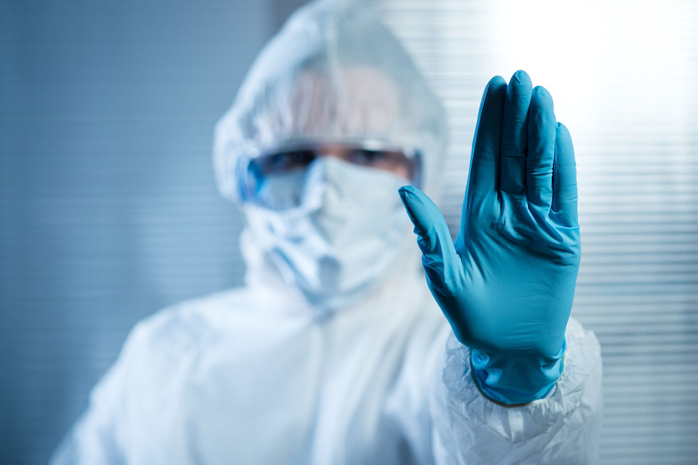 Female scientist in protective hazmat suit with hand raised